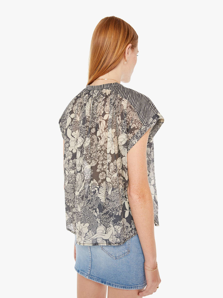 Back view of a black and white floral print button down blouse with a boxy fit.