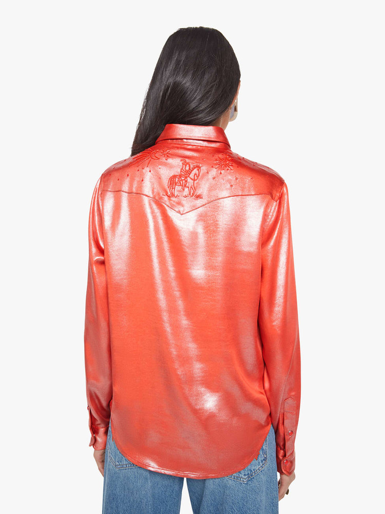 Back view of a woman in red foil denim button-up with front patch pockets and a curved hem.