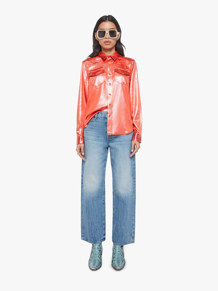 Full body view of a woman in red foil denim button-up with front patch pockets and a curved hem.