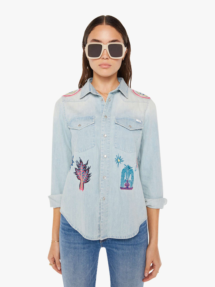 Front view of a womens denim shirt featuring embroidered details.