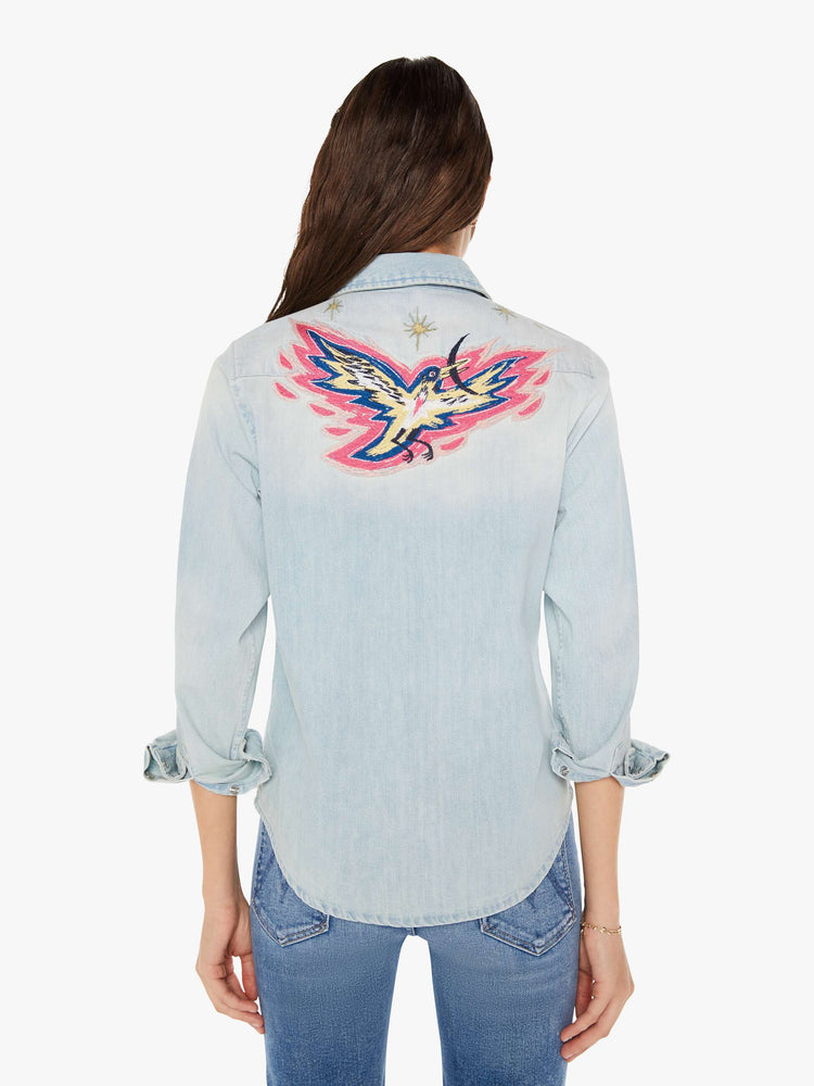 Back view of a womens denim shirt featuring embroidered details.