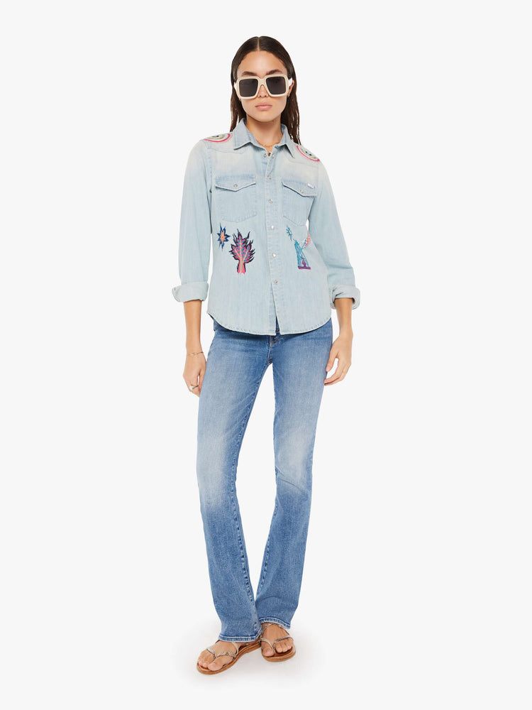 Front full body view of a womens denim shirt featuring embroidered details.