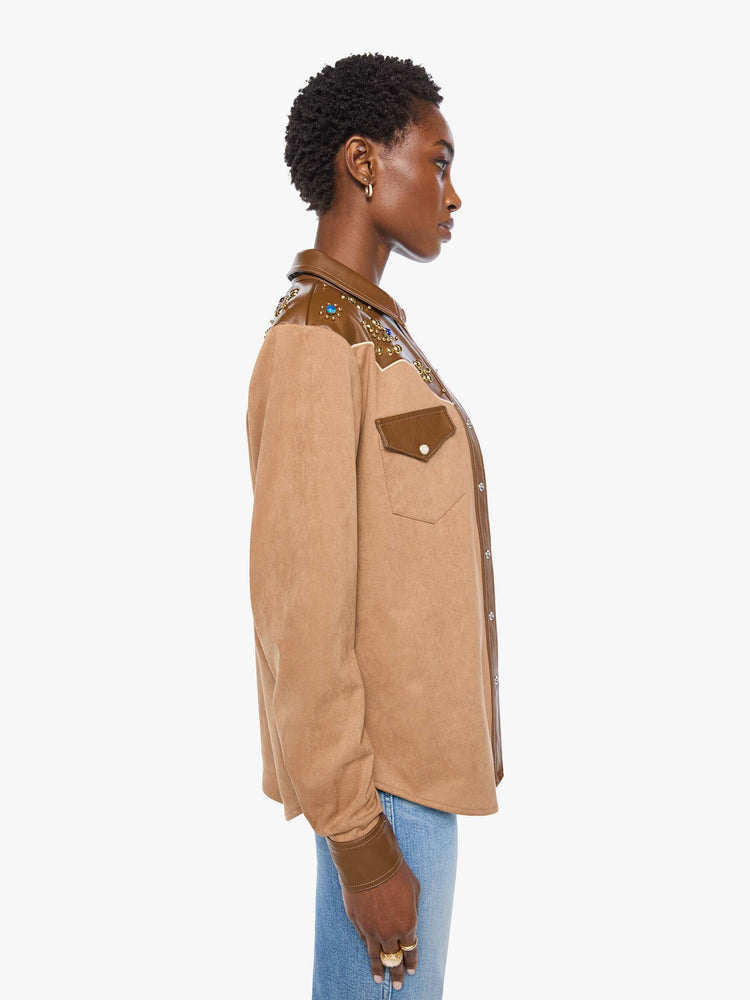 Side view of a woman faux suede and faux leather with studs and gemstone details button-up with a decorative yoke, patch pockets at the chest, snap closures and a curved hem. 