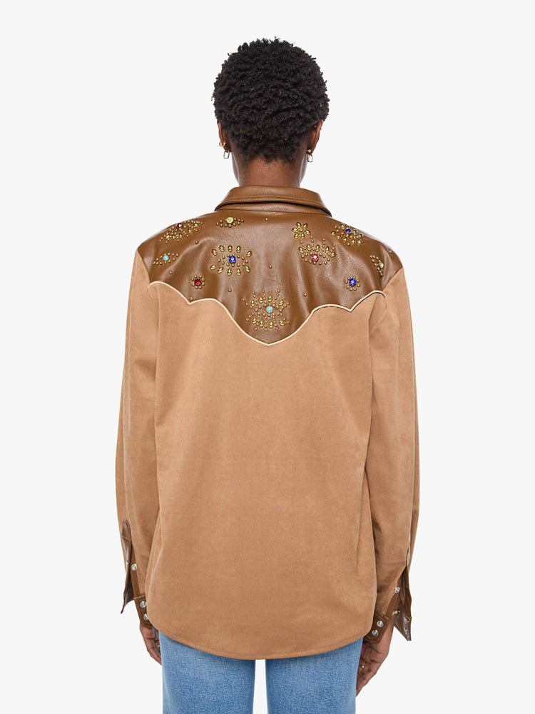 Back view of a woman faux suede and faux leather with studs and gemstone details button-up with a decorative yoke, patch pockets at the chest, snap closures and a curved hem. 