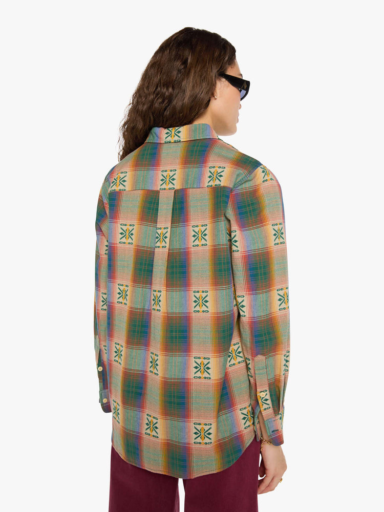 Back view of a woman in  plaid with embroidered details throughout button up.