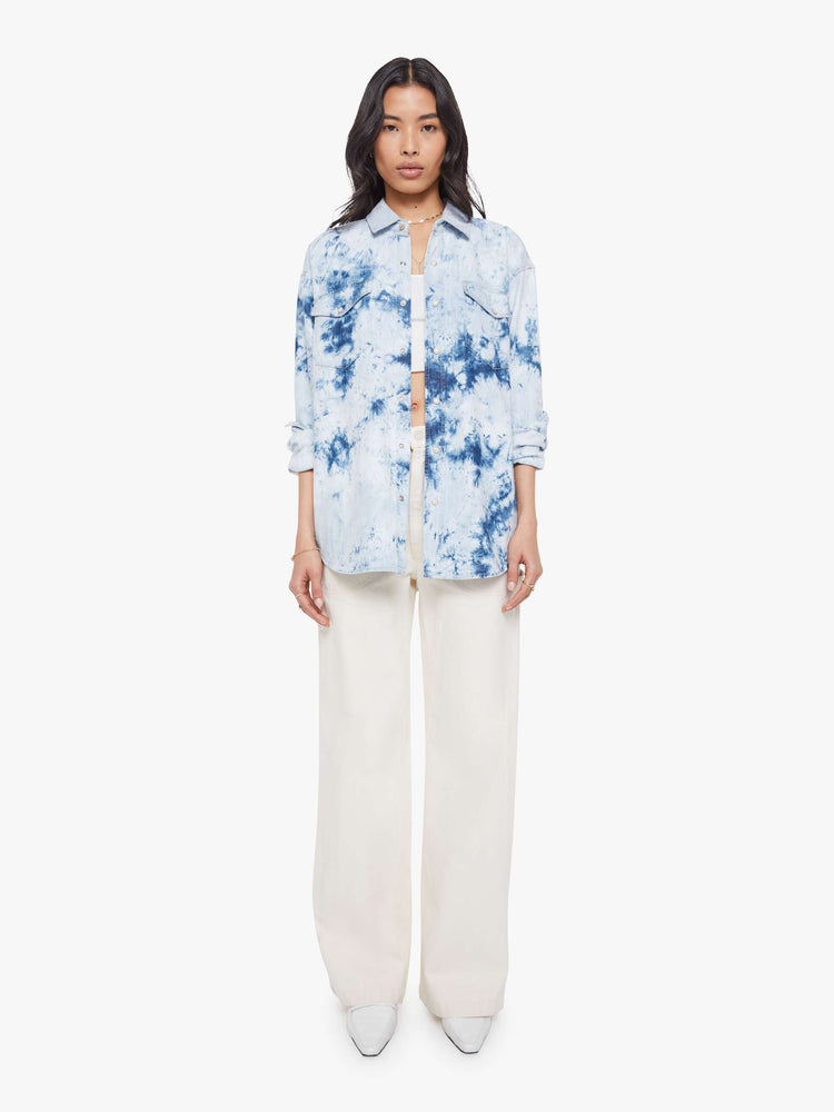 Full body view of a bleached tie die oversized button-up with drop shoulders, front patch pockets, a Western-inspired yoke and a curved hem.