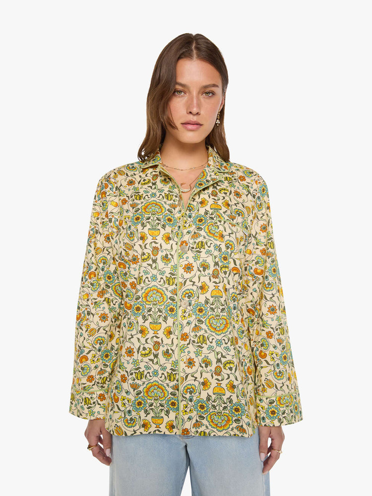 Front view of woman in two-piece pajama set includes a collared, long-sleeve button-up blouse with a patch pocket and boxy fit.