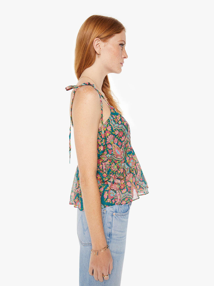 Side view of a womens spaghetti strap top featuring a colorful rug inspired print.