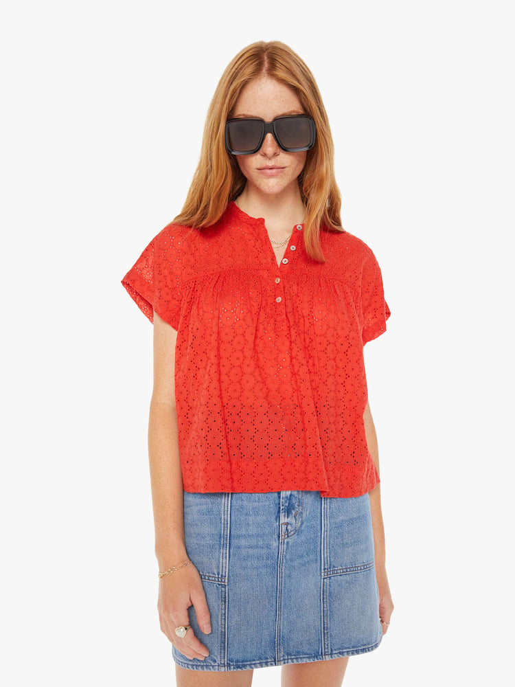 Front view of a woman red lightweight blouse with a buttoned V-neck, short boxy sleeves and ruffles across the chest for a loose, flowy fit.