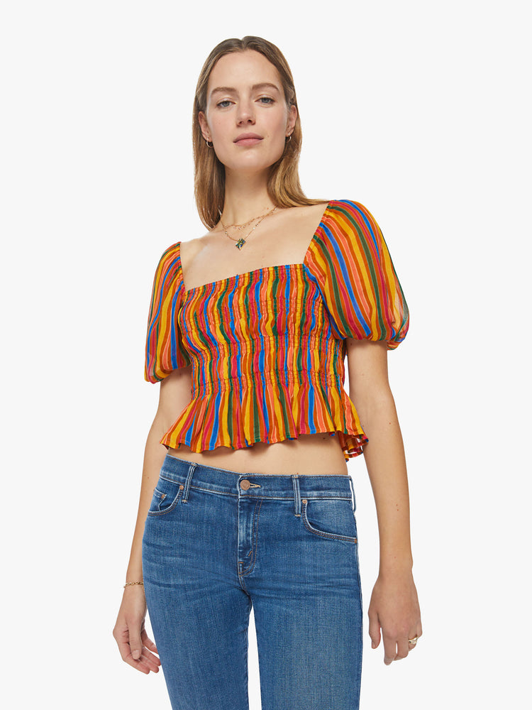 Front view of a womens top featuring a multi color stripe print, a square neckline, balloon short sleeves, and a smocked bodice.