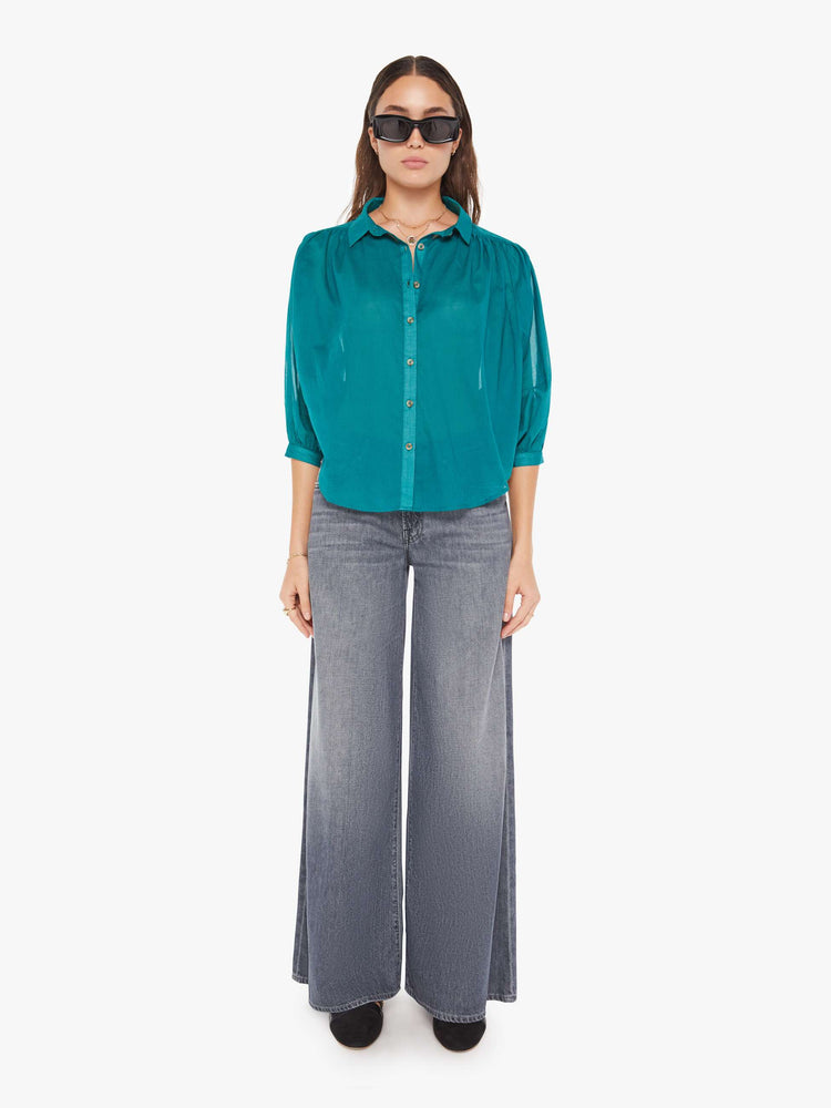 Front full body  view of a womens blouse in a teal green featuring a button down collar and 3/4 length sleeves.