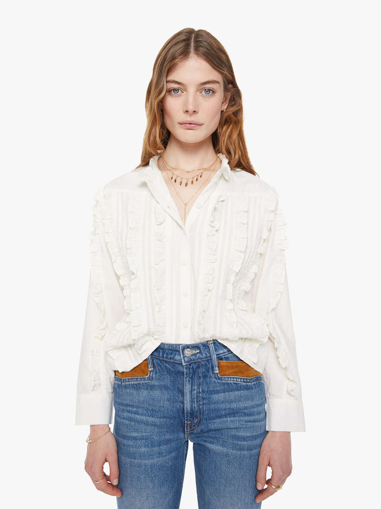 Front view button-up blouse with long sleeves, slightly dropped shoulders and a boxy fit.