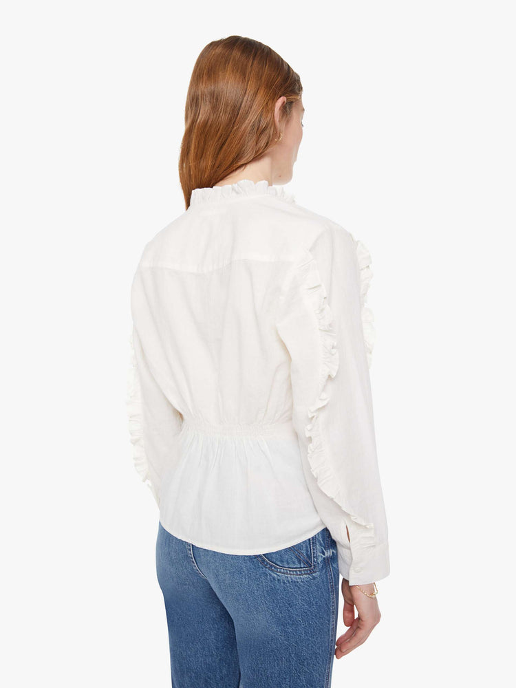 Back view button-up blouse with long sleeves, slightly dropped shoulders and a boxy fit.