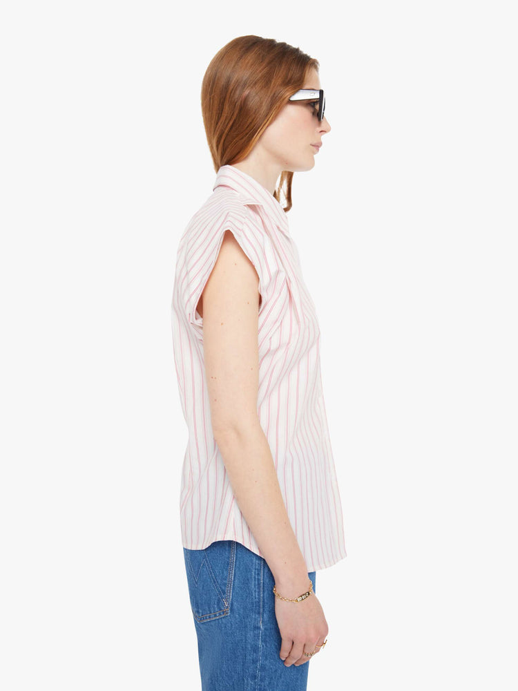 Side view of a light pink stripe pattern  short-sleeve button-up with an angled bodice and a curved hem. 
