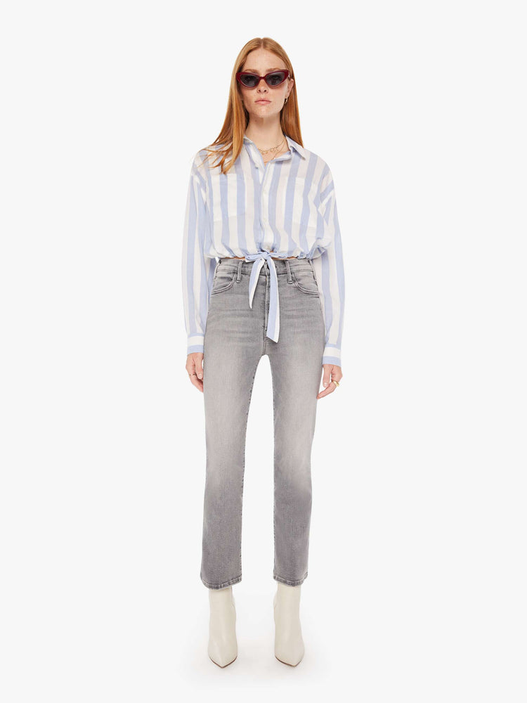 Front full body view of a womens button down shirt featuring a white a light blue stripe pattern and a cropped waist tie.