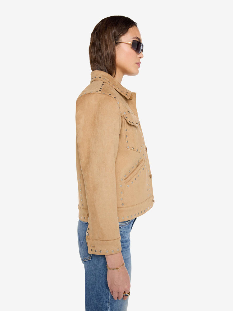 Side view of a woman in a khaki faux suede jacket features studded details throughout and off-white lining with navy doodles.