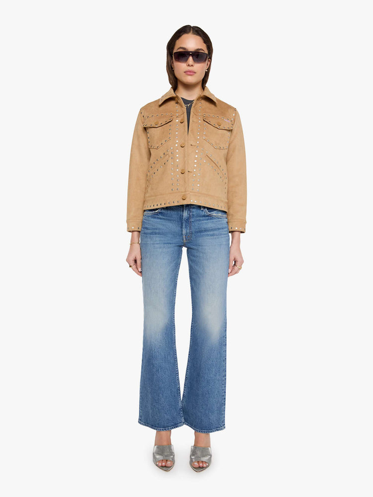 Front full body view of a woman in a khaki faux suede jacket features studded details throughout and off-white lining with navy doodles.