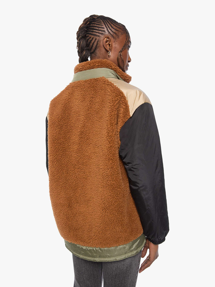 Back view of a woman in sherpa oversized jacket with a funnel neck, drop shoulders, a front patch pocket and zip closure.
