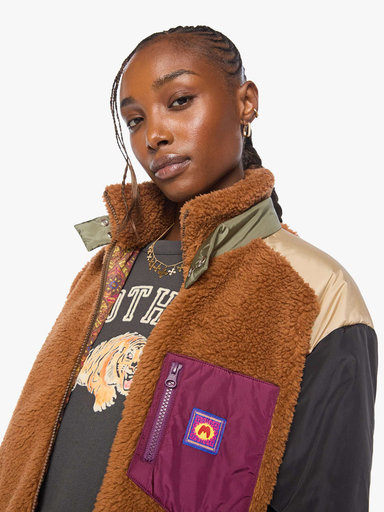 Close up view of a woman in sherpa oversized jacket with a funnel neck, drop shoulders, a front patch pocket and zip closure.