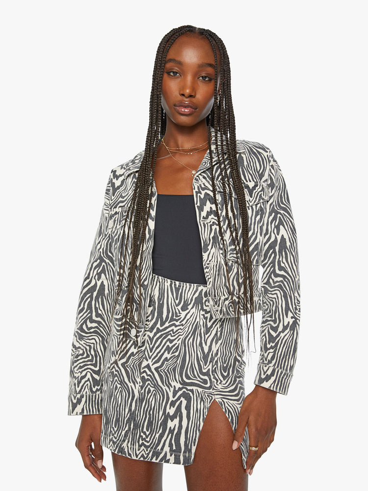 Front view of a woman denim boxy fit with oversized patch pockets and slight cropped hem jacket in a black and white zebra print.