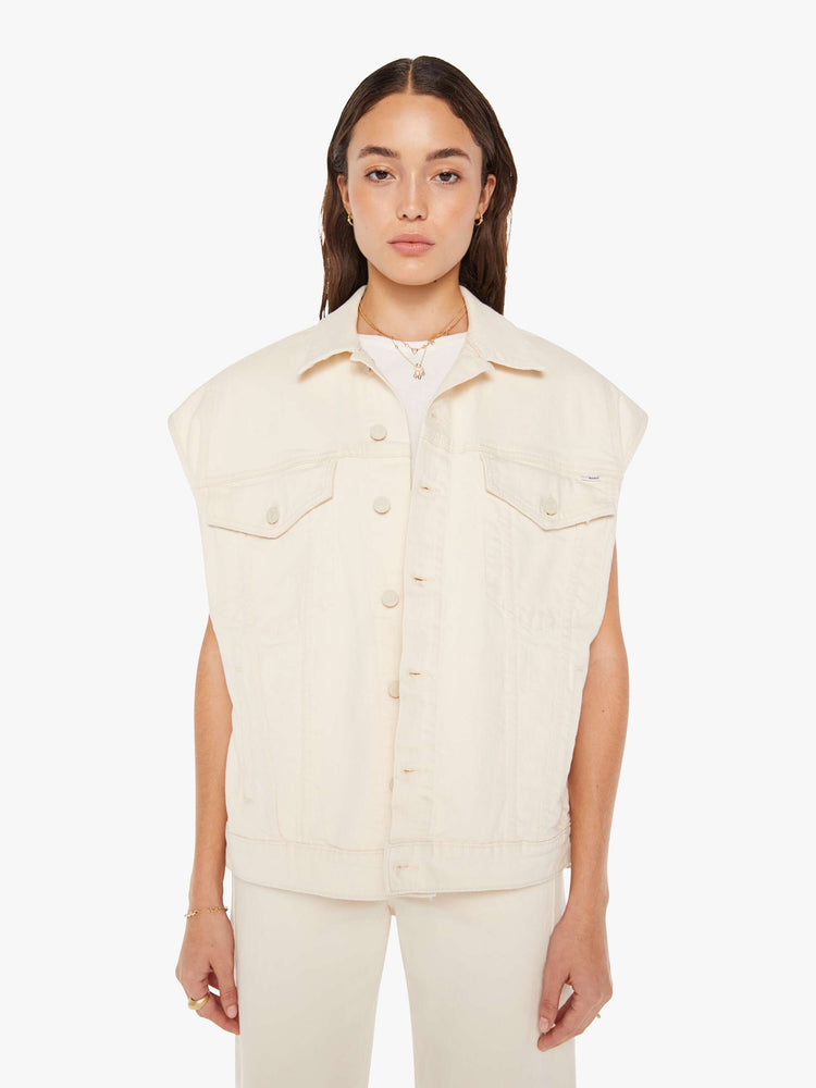 Front view of a woman creamy white hue oversized vest with extra-wide shoulders, patch pockets and a super boxy fit.