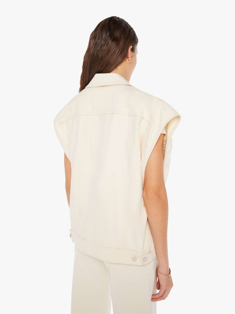 Back view of a woman creamy white hue oversized vest with extra-wide shoulders, patch pockets and a super boxy fit.