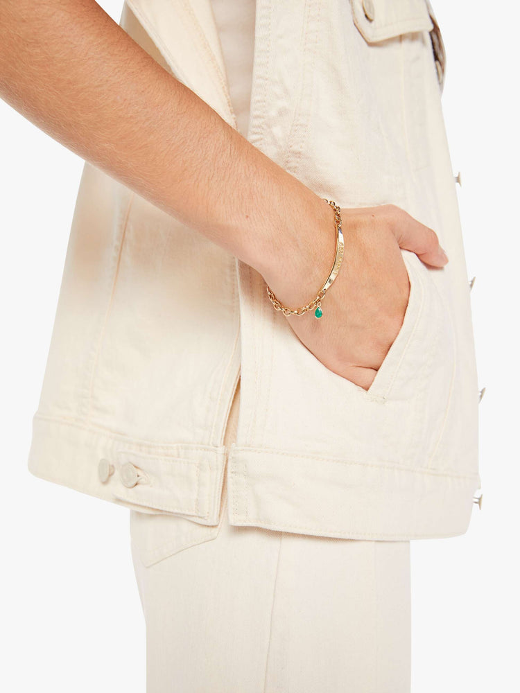 Pocket close up view of a woman creamy white hue oversized vest with extra-wide shoulders, patch pockets and a super boxy fit.
