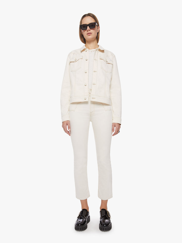 Full body view of woman creamy white classic denim jacket with front patch pockets, a Western-inspired yoke and a boxy fit.