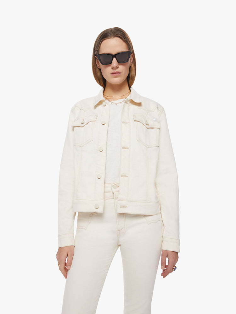 Front view of woman creamy white classic denim jacket with front patch pockets, a Western-inspired yoke and a boxy fit.