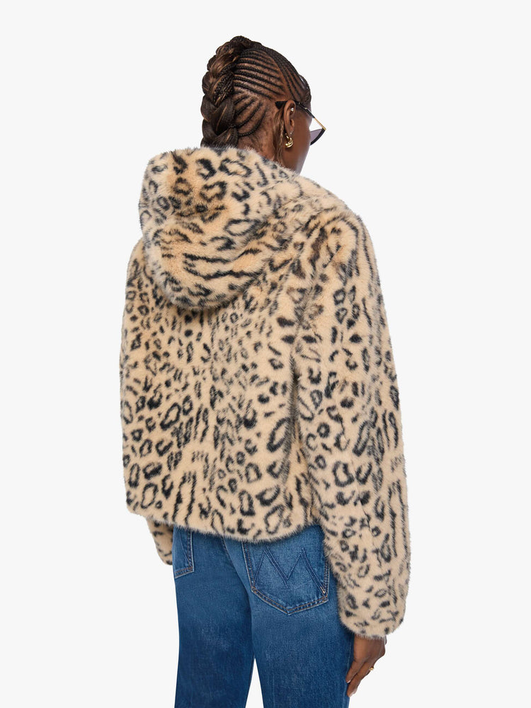 Back view of a woman in a light tan and black cheetah print zip-up hooded jacket with a slightly cropped fit.