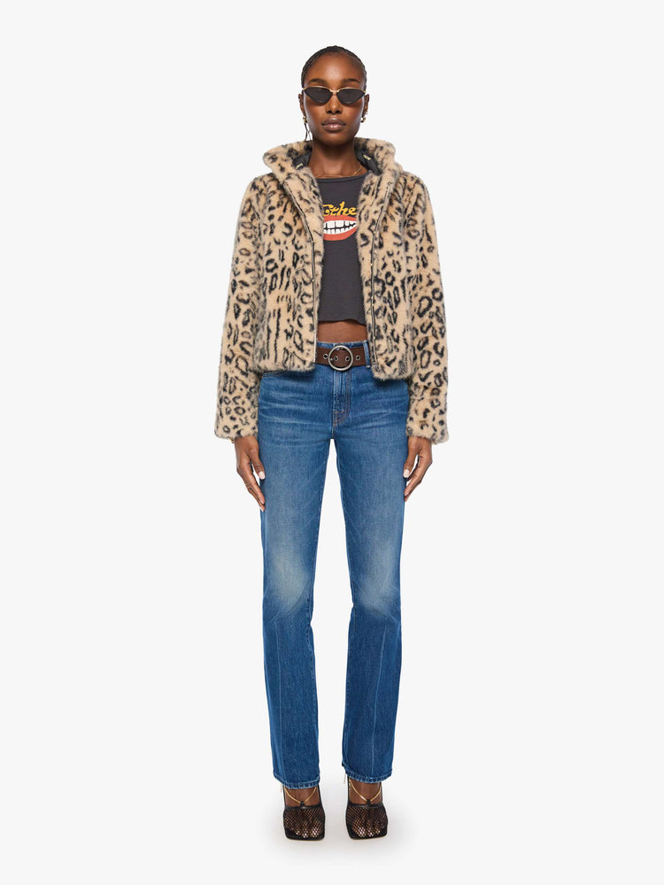 Full body view of a woman in a light tan and black cheetah print zip-up hooded jacket with a slightly cropped fit.