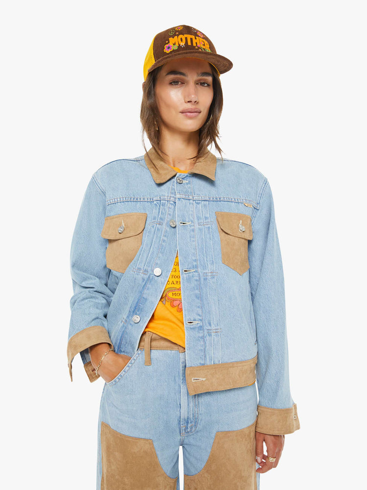 Front view of a woman in a light blue with suede oversized denim jacket with slit and patch pockets, pleated details and a boxy fit.