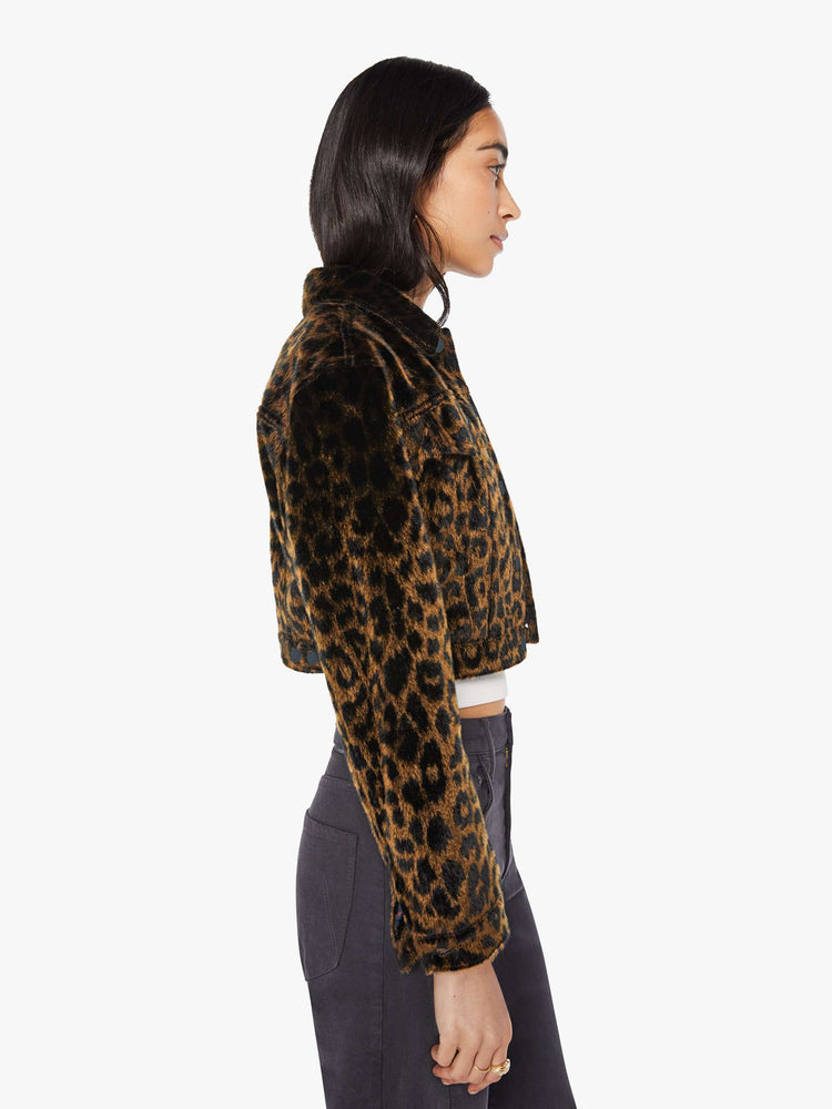 Side view of a woman in leopard print cropped collared jacket with patch pockets, a waist-length hem and buttons down the front.