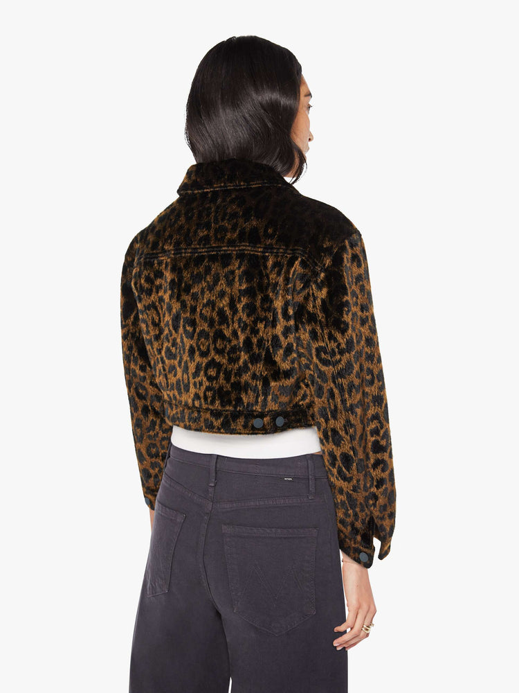 Back view of a woman in leopard print cropped collared jacket with patch pockets, a waist-length hem and buttons down the front.