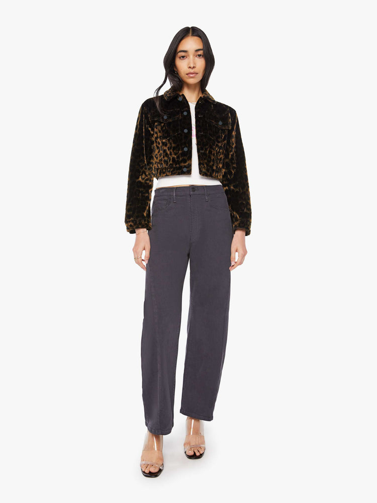 Front full body view of a woman in leopard print cropped collared jacket with patch pockets, a waist-length hem and buttons down the front.