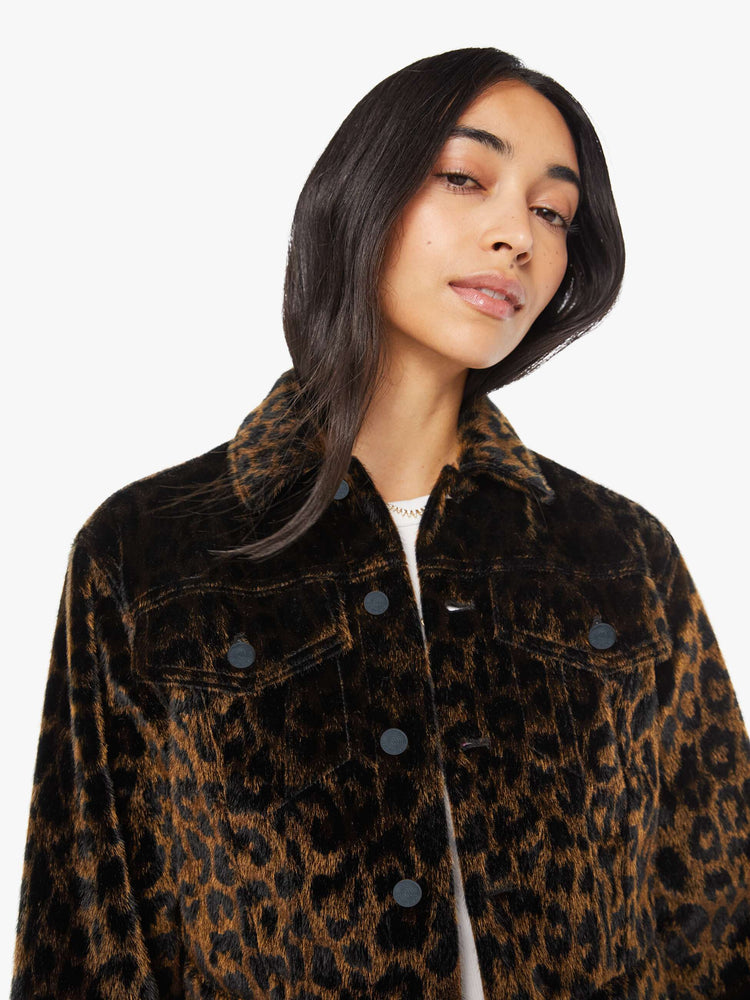 Front close up view of a woman in leopard print cropped collared jacket with patch pockets, a waist-length hem and buttons down the front.
