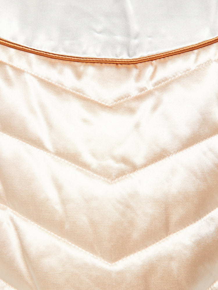 Swatch view of a woman letterman jacket has ribbed hems, slit pockets and a slightly cropped fit in a baby pink with white and orange detailing.