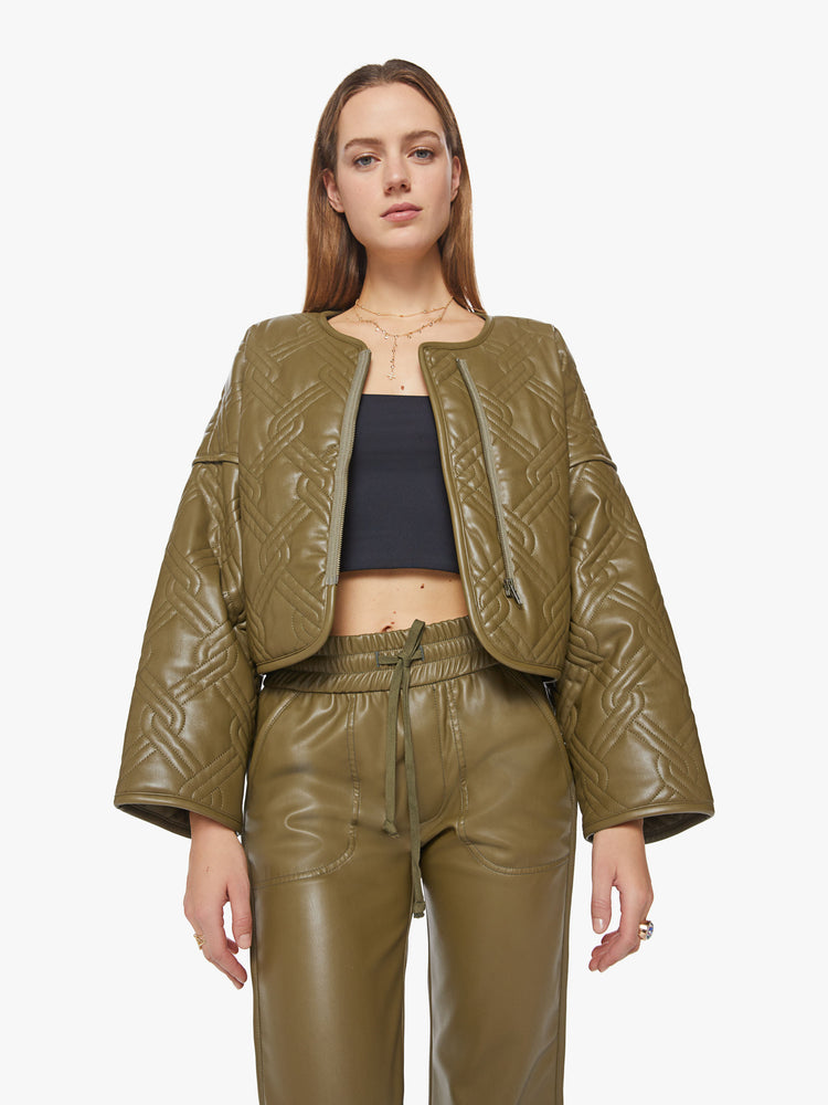Front view of a womans fir green hue faux leather boxy zip-up jacket with drop shoulders, extra-wide long sleeves and a cropped hem.