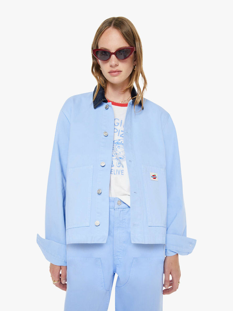 Front view of a woman a button-up jacket with drop shoulders, oversized patch pockets and a boxy fit.