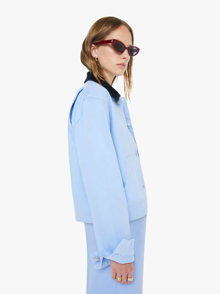 Side view of a woman a button-up jacket with drop shoulders, oversized patch pockets and a boxy fit.