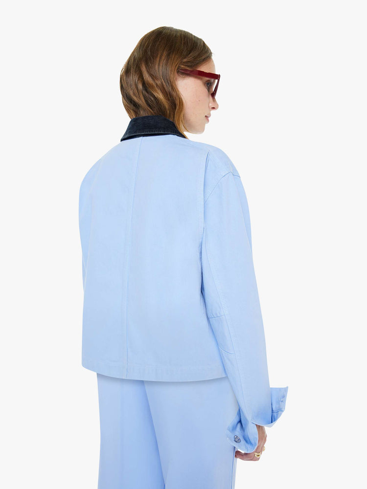 Back view of a woman a button-up jacket with drop shoulders, oversized patch pockets and a boxy fit.