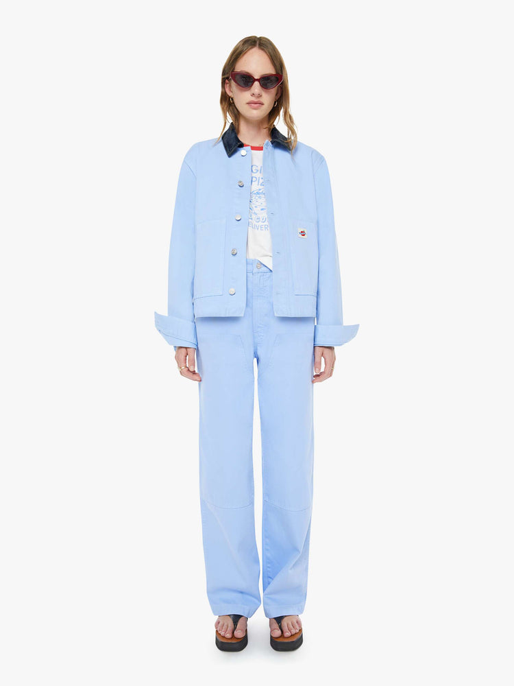 Full body view of a woman a button-up jacket with drop shoulders, oversized patch pockets and a boxy fit.