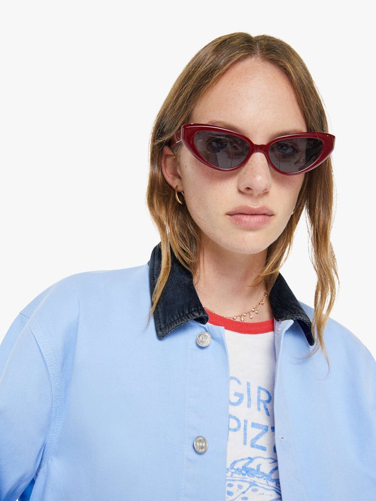 Close up view of a woman a button-up jacket with drop shoulders, oversized patch pockets and a boxy fit.