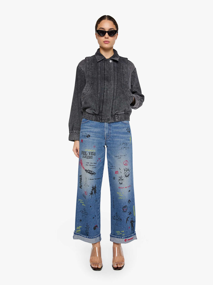 Front view of a woman in a faded grey  jacket is designed with drop shoulders, seamed details, hidden Velcro pockets, an elastic hem and a zip closure with a button flap. 