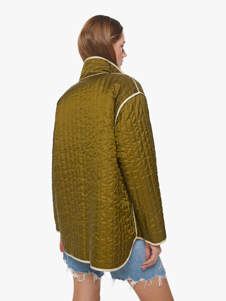 Back  view of a woman reversible zip-up jacket with drop shoulders, patch pockets and a boxy fit, army green on one side and cream on the other with angsty doodles in black.