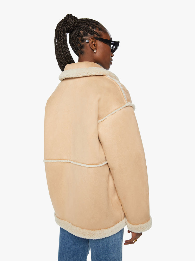Back view of a woman oversized car coat with drop shoulders, patch pockets, loop buttons and a boxy fit in light khaki with Western-inspired embroidery.