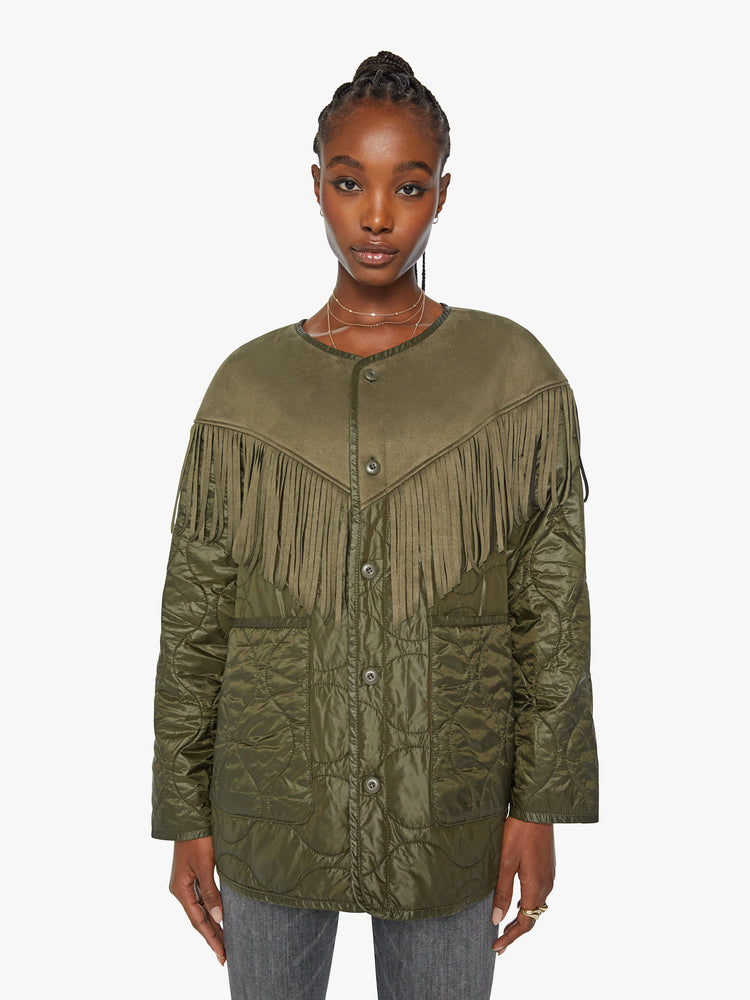 Front view of a woman with military liner jacket with a Western-inspired yoke, fringe trim and oversized patch pockets in an army green with faux-suede details.