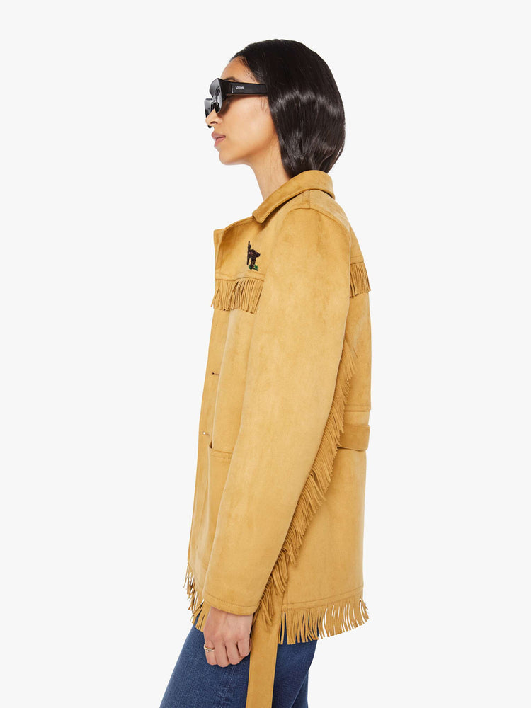 Side view of a woman in faux vintage-inspired jacket with a notched collar, oversized patch pockets, fringe details and an extra-long fit.