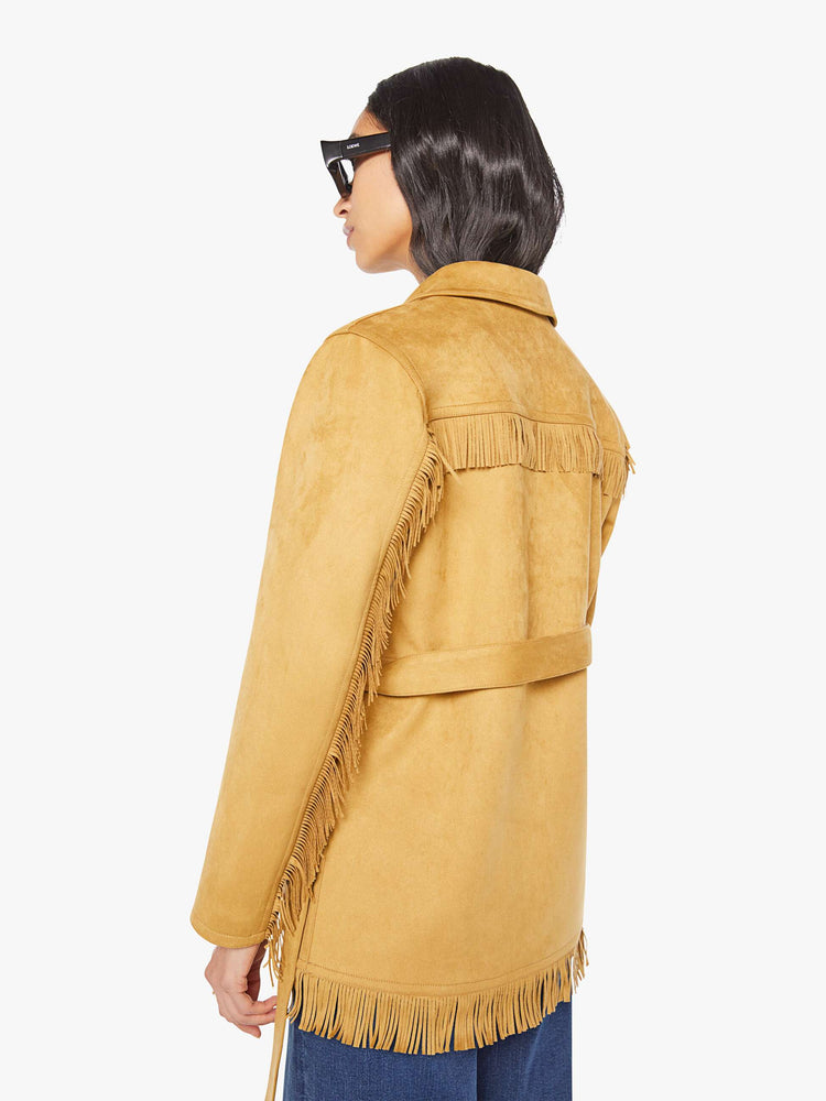 Back view of a woman in faux vintage-inspired jacket with a notched collar, oversized patch pockets, fringe details and an extra-long fit.
