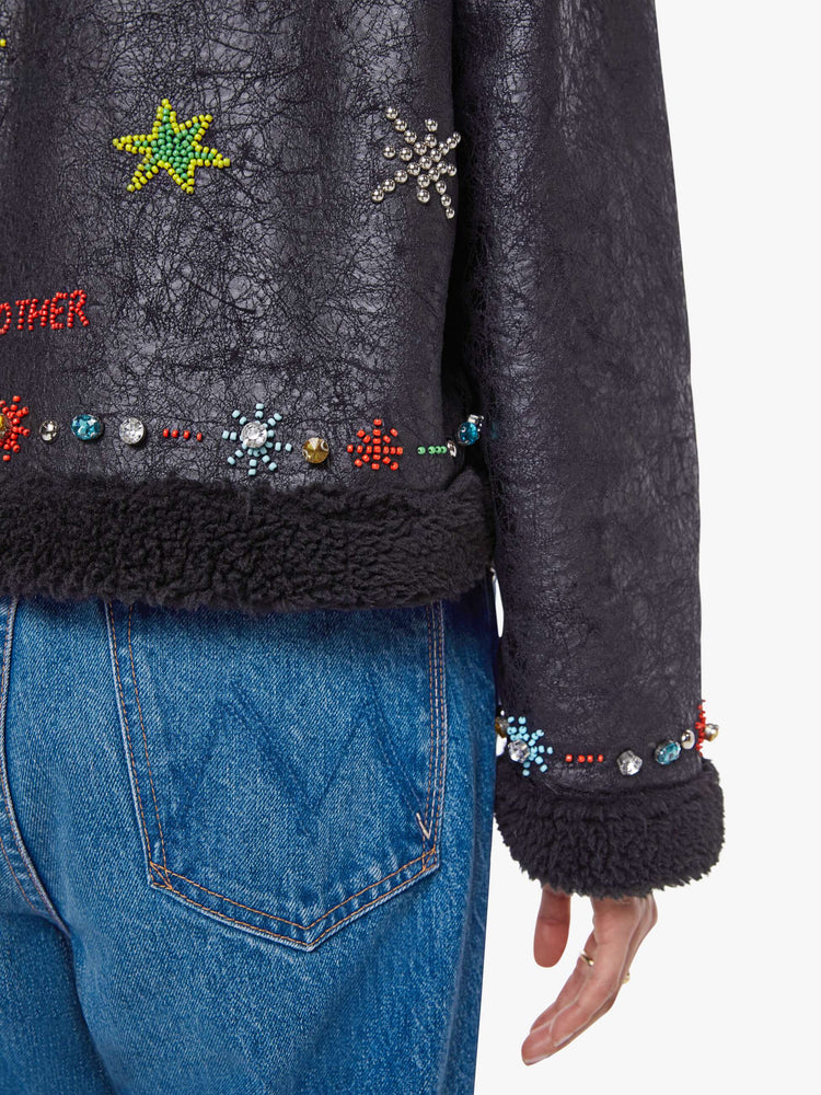 Swatch view of a woman in metallic black collared zip-up jacket with drop shoulders and a slightly cropped, boxy fit.